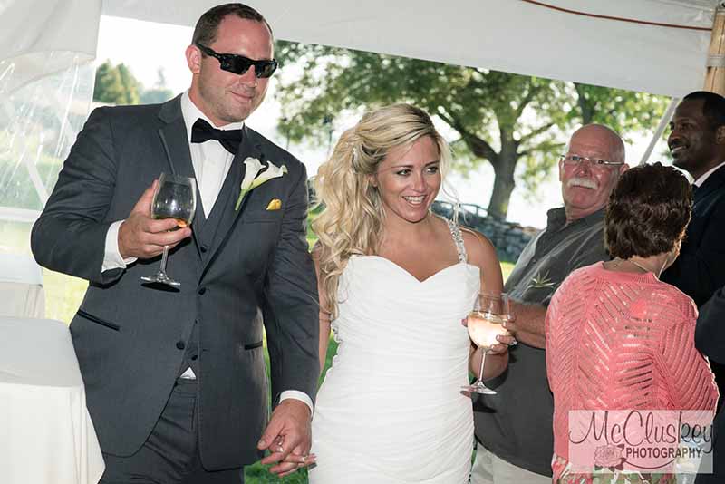 Bride and groom holding wine glasses