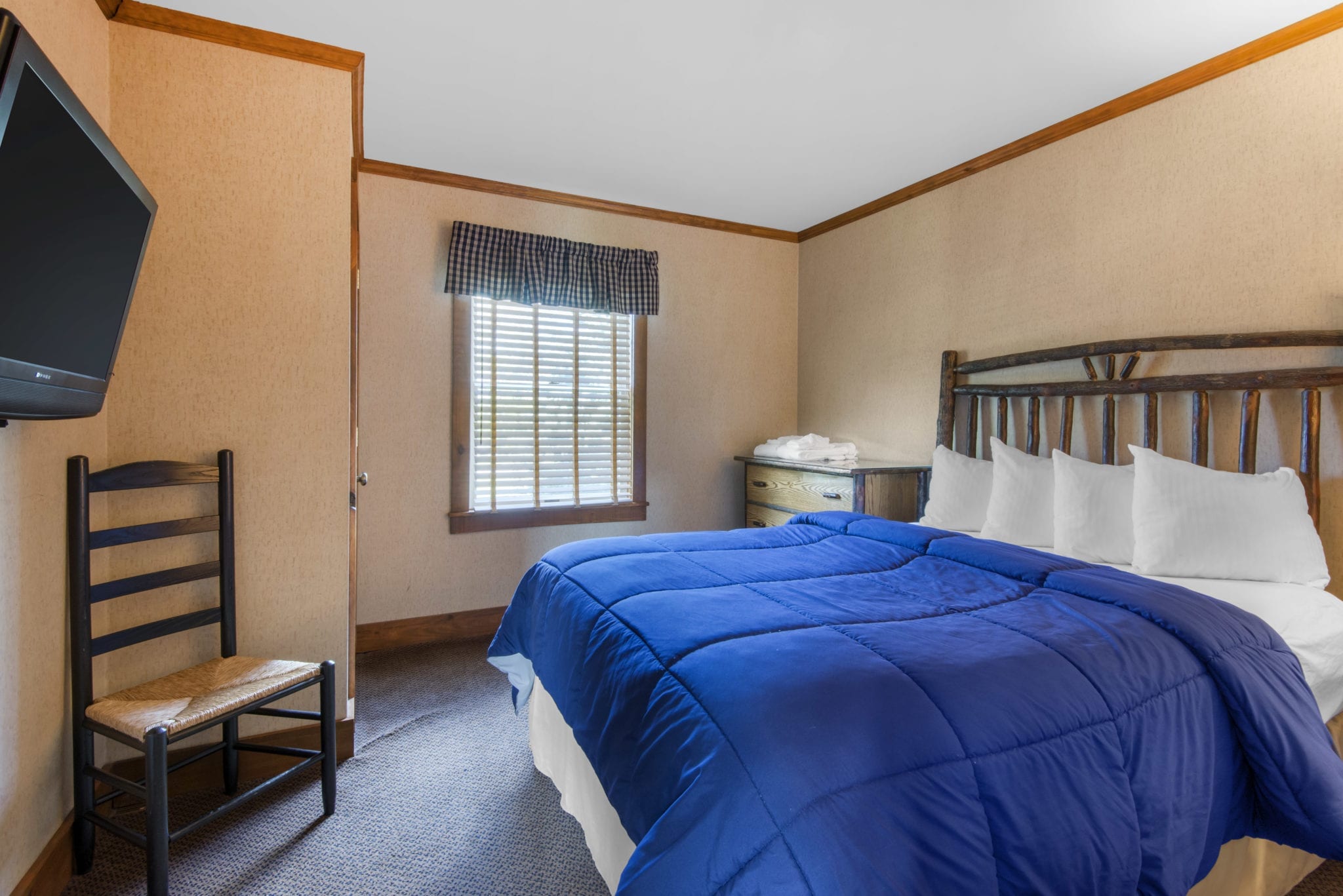 Cottage bedroom with queen bed.