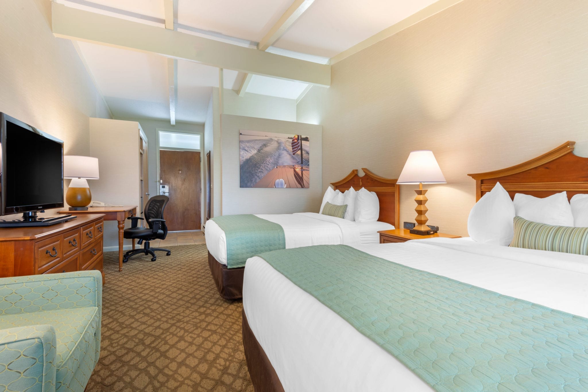 Bedroom with two queen beds viewed from window.